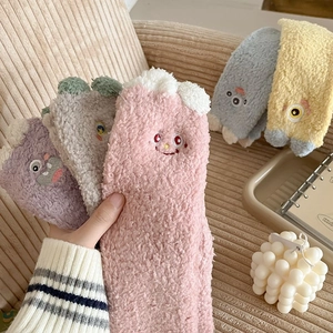 Detailed view of colorful coral fleece socks with cute cartoon facial embroidery