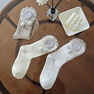Three pairs of knit baby mid-calf socks with lace trim and cute cat patches