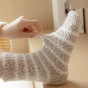 Close-up of flexible coral fleece striped socks showing superior elasticity and soft texture