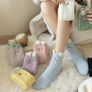 Close-up of thick coral fleece socks with cute 3D cartoon ears and embroidery detail