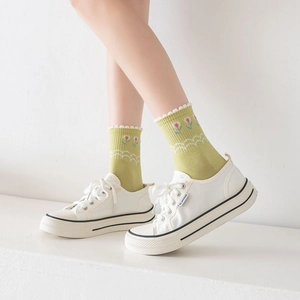Detail of avocado green mid-calf cotton socks with pink tulip pattern and wavy cuffs
