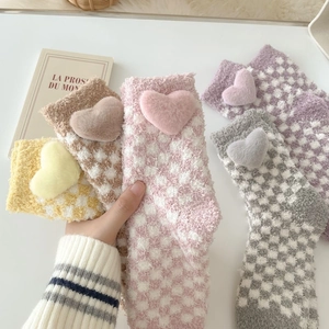 Detail of coral fleece thick socks with checkered pattern and plush 3D heart decor