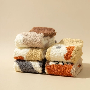 Close-up of thick coral fleece socks in warm multicolor tones with soft plush texture