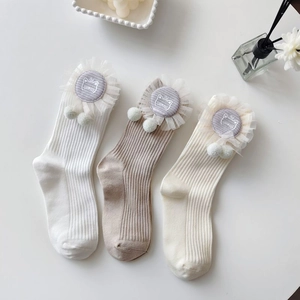Detailed macro view of ribbed cotton socks with lace trim and cute cat embroidery patches
