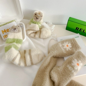 Detail showing soft fuzzy mink fleece socks with cute animal patterns and daisy motifs
