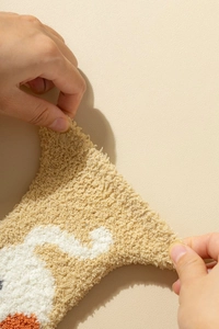 Close-up showing the high elasticity and soft coral fleece texture of the cat paw socks