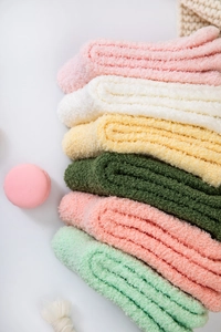 Detail view of thick coral fleece socks in multiple macaron colors for winter warmth