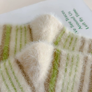Detailed macro view of soft striped mink velvet socks with fluffy plush texture