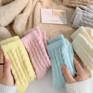 Detail view of colorful cable knit thermal plush socks in soft pastel color palette