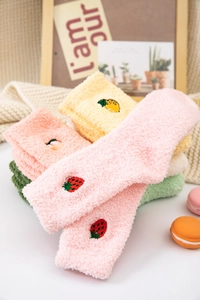 Detail of coral fleece socks with fruit embroidery and soft warm texture