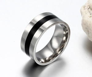 Detailed view of wide stainless steel ring with black enamel inlay on coral stone