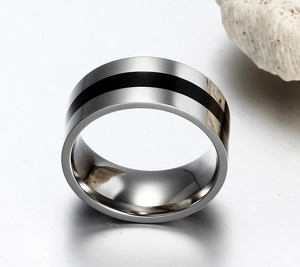 Macro shot of minimalist stainless steel ring with black enamel line inlay and polished finish
