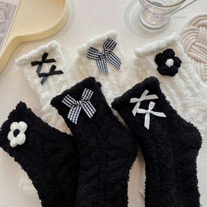 Plush coral fleece mid-calf socks for women in black and white with cute decorative bows