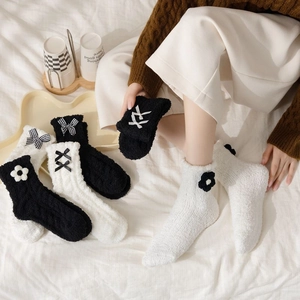 Warm coral fleece mid-calf socks with bows and floral details in black and white