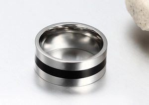 Detailed view of a wide stainless steel ring with black epoxy inlay and polished finish