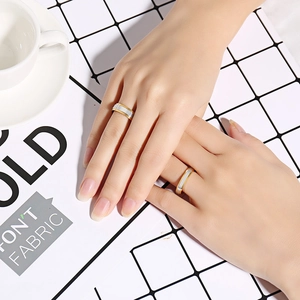 Close-up of 4mm and 6mm two-tone stainless steel rings on a hand for couples