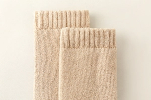 Detail shot of thick ribbed cuffs on beige sheep wool winter socks for extra warmth