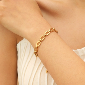 Minimalist 18K gold-plated stainless steel chain bracelet worn on a woman's wrist