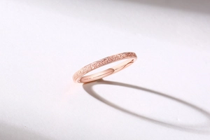 Macro detail of rose gold ring featuring a frosted sandblasted texture and smooth interior