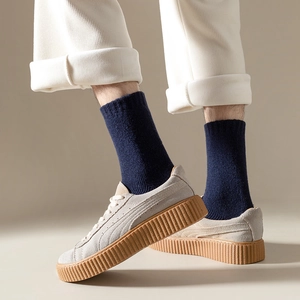 Deep blue wool socks worn with grey platform sneakers and corduroy trousers