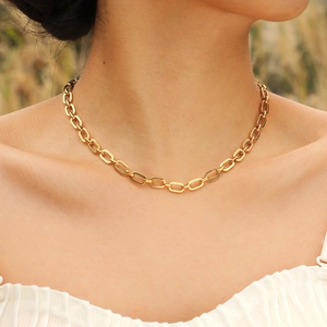 Golden paperclip link chain necklace in 18K gold finish styled on model for minimalist look