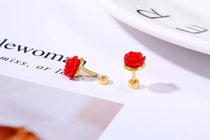Macro shot of red rose titanium steel earrings with secure gold-plated screw backs