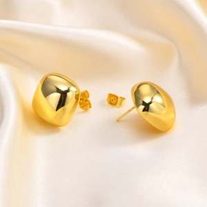 Close-up of square 18K gold-plated geometric stud earrings on champagne silk fabric