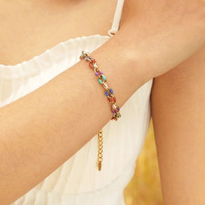 Close-up of colorful enamel chain bracelet in 18K gold plating worn on a wrist