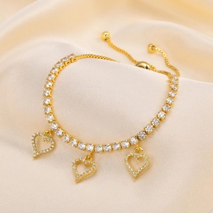 Adjustable gold tennis bracelet with zircon-encrusted heart charms on champagne silk