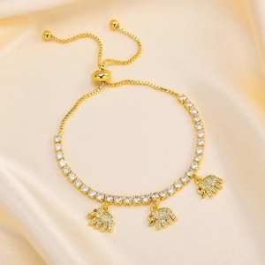 Detail of adjustable gold tennis bracelet with zircon elephant charms on satin