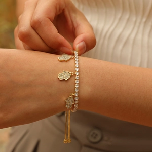 Close-up of gold Hamsa Hand bracelet with white zircon and adjustable sliding clasp