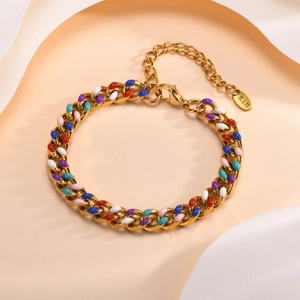 Macro detail of 18K gold Cuban chain bracelet featuring colorful enamel inlays and K18 tag