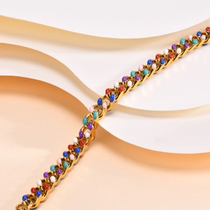 Close-up of gold Cuban chain bracelet featuring vibrant multi-color enamel inlay details