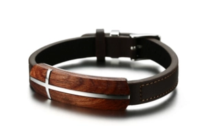 Close-up of men's leather bracelet featuring rosewood inlay and silver cross detail
