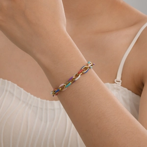 Detail of 18K gold plated Cuban chain bracelet with colorful enamel oval links on wrist