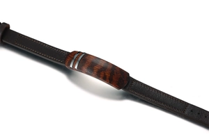 Macro view of brown leather men's bracelet with wood grain inlay and silver accents