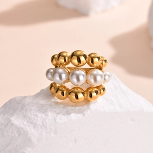 Three-layer gold beaded ring with central pearls on stone pedestal for women