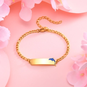 Detailed shot of golden stainless steel Figaro bracelet with blue dolphin charm and plate