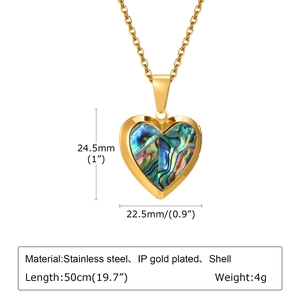 Detailed view of heart locket pendant with abalone shell inlay and gold-plated steel chain