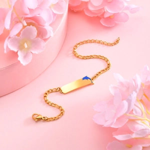 Golden 3:1 NK chain bracelet featuring a blue enamel dolphin on a rectangular ID plate