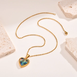 Gold stainless steel heart locket necklace featuring iridescent rainbow abalone shell inlay