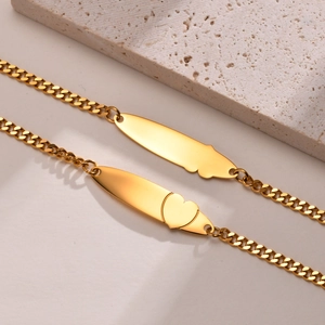 Macro shot of gold stainless steel cuban chain bracelet with engravable heart plate