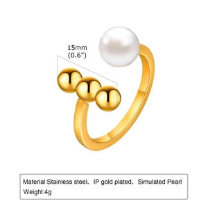 Detailed view of open ring with white pearl and three gold beads on stainless steel band