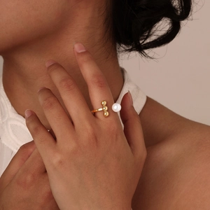 Golden stainless steel open ring featuring three small gold beads and a white pearl decor