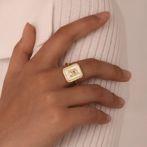 Golden geometric octagonal shell ring with zircon inlay worn on a female hand