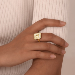 Detail of a gold geometric octagonal ring with shell inlay and zircons on a model