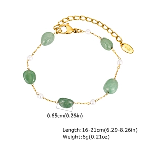 Detail of gold chain bracelet with green gemstone, pearls and K18 hallmark tag