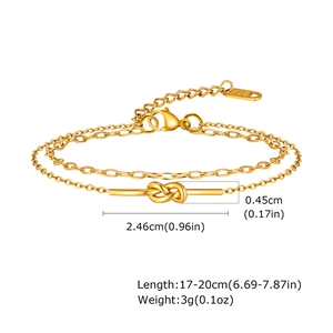Detail showing gold double-layer chain bracelet with knot charm and K18 hallmark tag