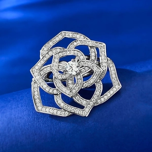 Macro shot of silver camellia ring with sparkling crystal pavé and center round stone