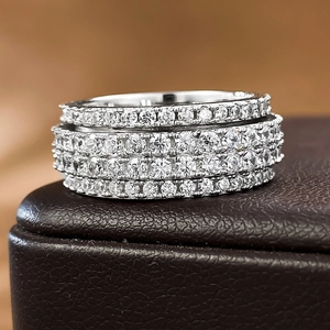 Luxurious silver spinning ring featuring four rows of sparkling round-cut moissanite stones